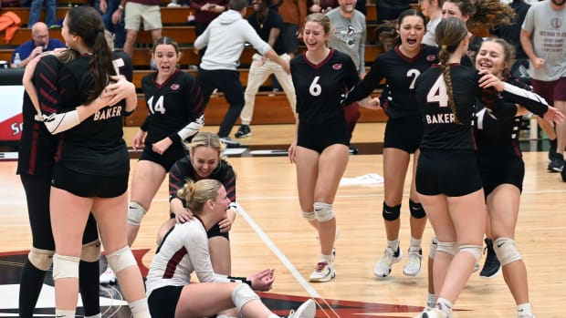 Baker players celebrate the first girls volleyball state championship on school history after beating Branford in four sets at the FHSAA girls volleyball championships Tuesday at Polk State College in Winter Haven. 